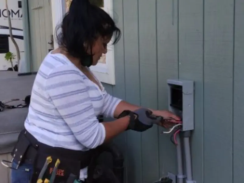 Licensed electrician wiring an exterior subpanel in Taylor